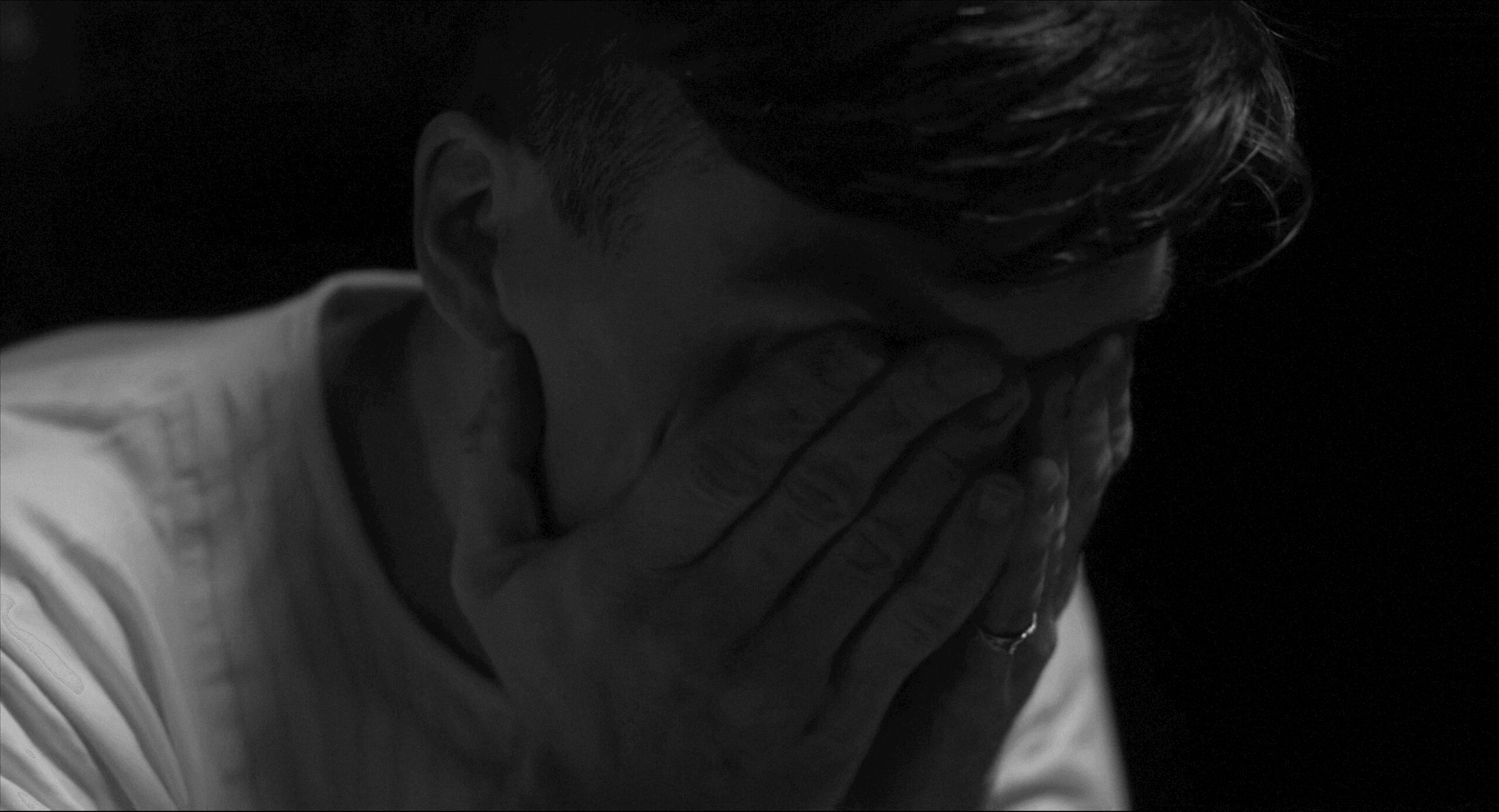 Man covering his face in frustration, representing anger management therapy