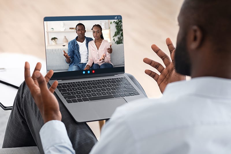 Person in a comfortable home setting during a virtual therapy session