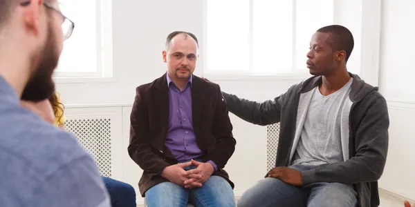 Therapist and client in a compassionate inquiry therapy session