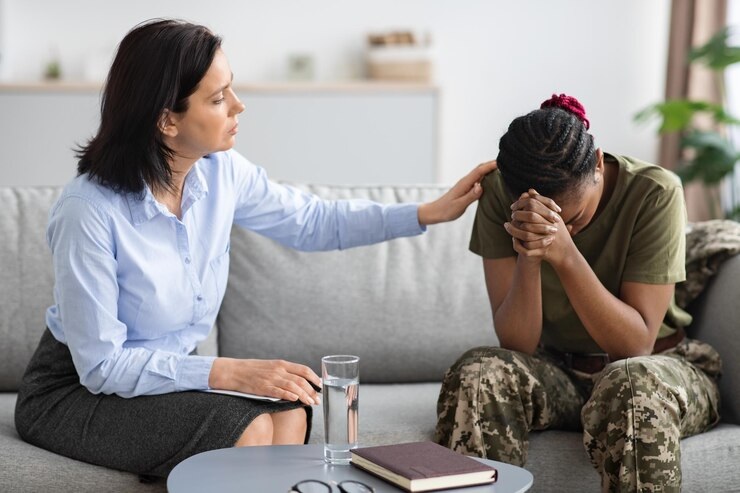 Person coping with PTSD symptoms, representing trauma-informed therapy
