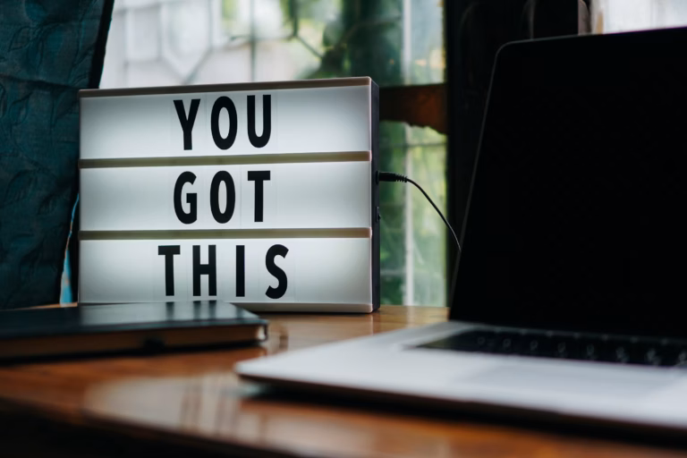 Motivational light box saying "You Got This" and a laptop, supporting anxiety and wellness therapy.